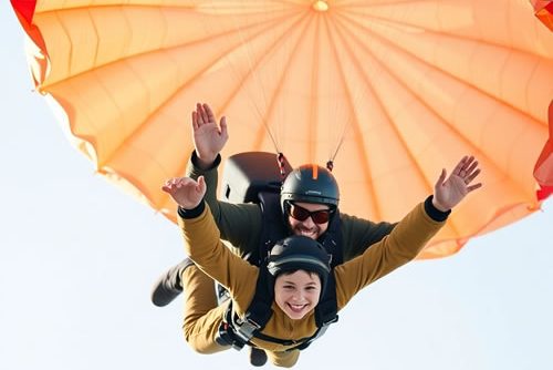 cropped-A-horizontal-image-of-a-boy-and-instructor-tandem-skydiving-image